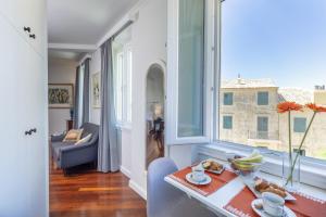 a dining room with a table and a window at Dousmani Corfu Old Town Studio Suite in Corfu Town