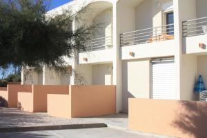 a white house with brown boxes in front of it at Les Stoechades in Hyères