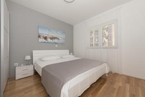 Posteľ alebo postele v izbe v ubytovaní Apartman IVONA