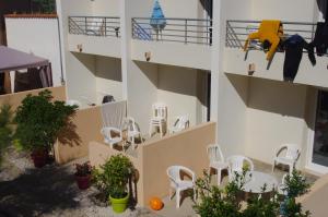 a group of chairs sitting on the side of a building at Les Stoechades in Hyères