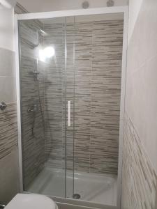 a shower with a glass door in a bathroom at House on Anagnino 64 in Ciampino