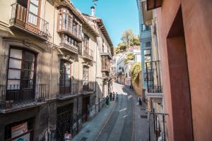 an empty street in a city with buildings at tuGuest Plaza Nueva Apartment in Granada