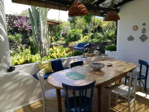 a dining room with a table and chairs and a garden at La Rosamarina in Stromboli
