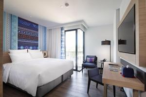 Novotel Chiangmai Nimman Journeyhub客房内的一张或多张床位