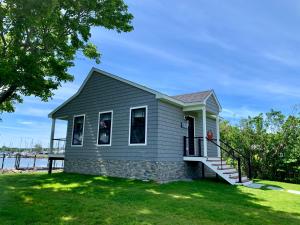 a tiny house on the shore of a lake at Harbor View Landing in Mystic