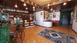 a large room with a store with dishes on the walls at Hotel Astoria in Tabiano