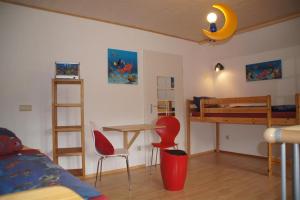 a bedroom with a bunk bed and a table and chairs at Biohof Schad in Eisenbach