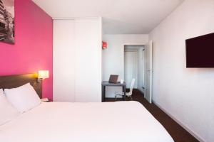 Кровать или кровати в номере Aparthotel Adagio Access Strasbourg Petite France