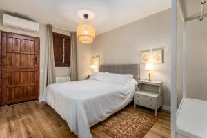 Postel nebo postele na pokoji v ubytování Alquería Calatrava B&B