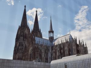 a large cathedral building with spires on top of it at Hotel Mondial am Dom Cologne MGallery in Cologne