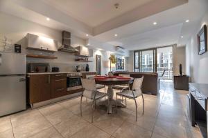 a kitchen with a table and chairs in it at 706 Canal Quays in Cape Town