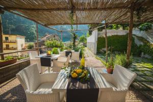 a table and chairs on a patio with a view at Aquarius Maiori B&B in Maiori