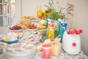 a table topped with plates and bowls of food at Aquarius Maiori B&B in Maiori