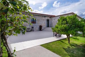 a patio in front of a stone house at Casa d'Amares in Amares