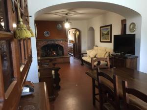 a living room with a couch and a fireplace at PIAN DEL LECCIONE in Manciano