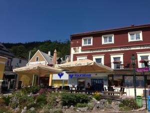 a building with tables and umbrellas in front of it at Magnus Klause in Mariazell