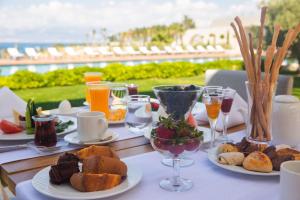 a table topped with plates of food and drinks at ON'LIVE HOTEL in Çeşme