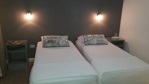 two beds in a room with two pillows on them at Las Toscas Apart in Curuzú Cuatiá