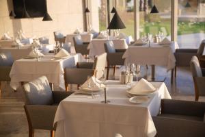 a row of tables and chairs with white table cloth at ON'LIVE HOTEL in Çeşme