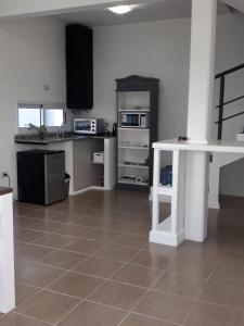 a kitchen with a white table in a room at Las Toscas Apart in Curuzú Cuatiá