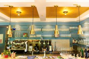 a bar with several lights hanging from the ceiling at Hotel Garni Goldammer in Dießen am Ammersee