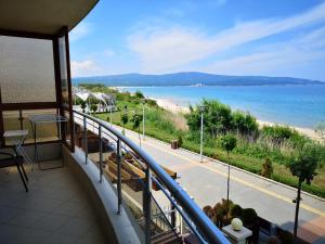 a balcony with a view of a beach and the ocean at Albatros Private Studio in Primorsko