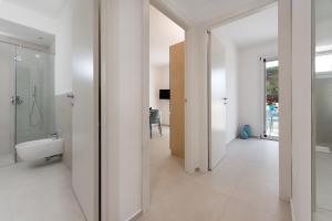 a white bathroom with a shower and a toilet at Vitop Residence in San Vito lo Capo