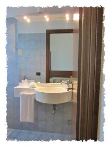 a bathroom with a sink and a mirror at Hotel Green castellani in Vicenza