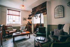 a living room with couches and chairs and a table at Weavers Guesthouse by Weavers of Haworth in Haworth