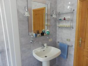 a bathroom with a sink and a mirror at Casavacanze PugliaMia in Grottaglie +61 photos