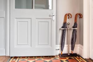 two umbrellas on display next to a door at The Dartmouth Boutique B &B in Dartmouth