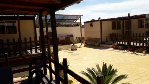 a patio with a fence and a house at VILLAGGIO STAGNONE in Marsala