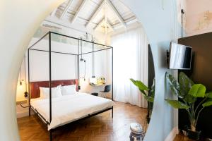 a bedroom with a canopy bed in a room at The Trilogy House in Thessaloniki