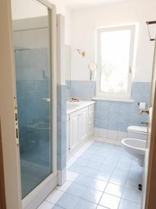 a bathroom with a shower and a toilet and a sink at Villa Luce B&B in Olbia