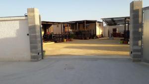 an open garage door of a building with a courtyard at VILLAGGIO STAGNONE in Marsala