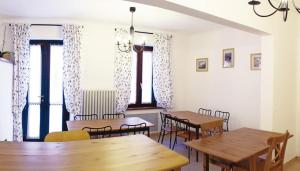 a dining room with tables and chairs and windows at B&B Indipendenza in Civitanova Marche