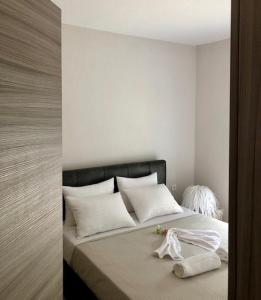 a bedroom with a bed with white pillows at Sofimel Apartment in Skala Sotiros