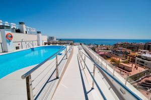 a view from the balcony of a building with a swimming pool at Bahía Almuñecar in Almuñécar