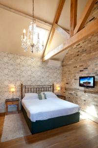 A bed or beds in a room at The Fox by Greene King Inns 