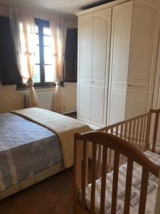 a bedroom with a large bed and a window at Le case della baracchina in Pisa