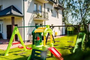 a playground in the yard of a house at Apartamenty i pokoje Sosnowa 4 Dębki in Dębki