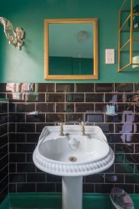 a bathroom with a white sink and a mirror at Golden Eagle in Chester