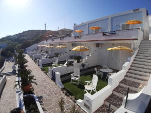 a building with chairs and tables and umbrellas at Villa Flavia - Adults Only in Ponza
