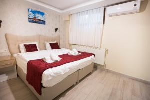 Postel nebo postele na pokoji v ubytování T-Square Residence