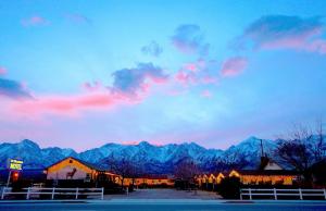 a view of a mountain range with a cloudy sky at Mt Williamson Motel and Basecamp in Independence