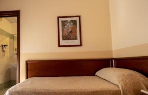 Postel nebo postele na pokoji v ubytování Hotel Gangi