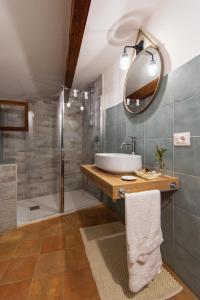 a bathroom with a tub and a sink and a shower at Aurora Medieval House in Sermoneta +88 photos