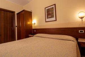 Postel nebo postele na pokoji v ubytování Hotel Gangi