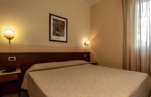 Postel nebo postele na pokoji v ubytování Hotel Gangi