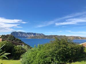 a view of a lake with mountains in the background at Villaggio Est a Capo Coda Cavallo San Teodoro in San Teodoro